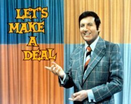 Let's Make A Deal image with Monty Hall hosts this hilarious half-hour gameshow in which audience contestants picked at random, dressed in ridiculous costumes, try to win cash or prizes by choosing curtain number 1, 2 or 3.